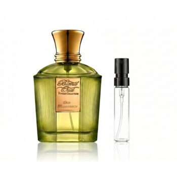 Green glass perfume bottle with a gold cap and peach label, shown with a clear spray atomizer beside it on a white background.