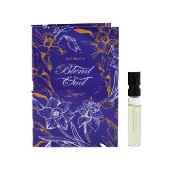 Purple perfume gift box with a gold floral design and script reading 'Blend Oud' placed beside a small clear fragrance roller bottle.