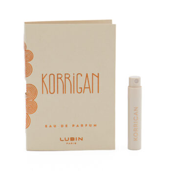 Box and small spray bottle of Korrrigan by Lubin Paris, beige packaging with orange text and circular designs, eau de parfum label nearby.
