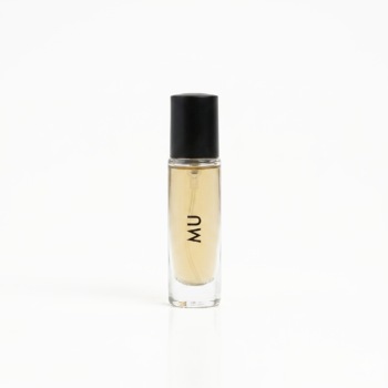 Close-up of a narrow glass perfume bottle with a black cap and pale amber liquid, centered on a white background.