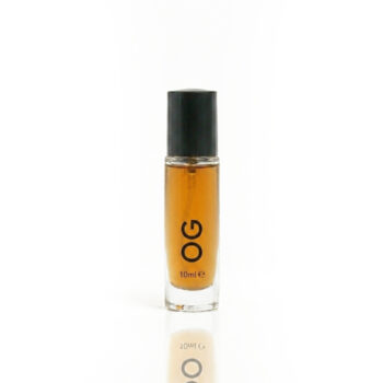 Small glass perfume bottle with orange liquid and a black cap, 10 ml on a white surface.