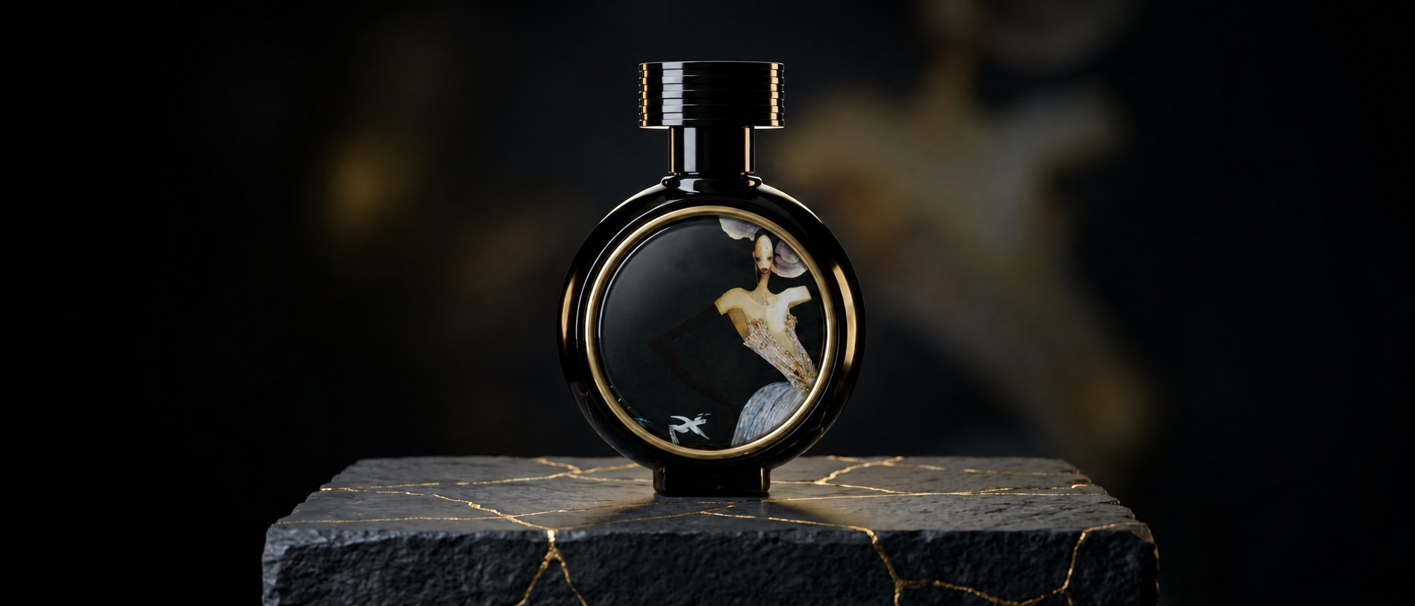 Elegant black round perfume bottle with gold trim and a painted inset, resting on a dark, textured stone pedestal.