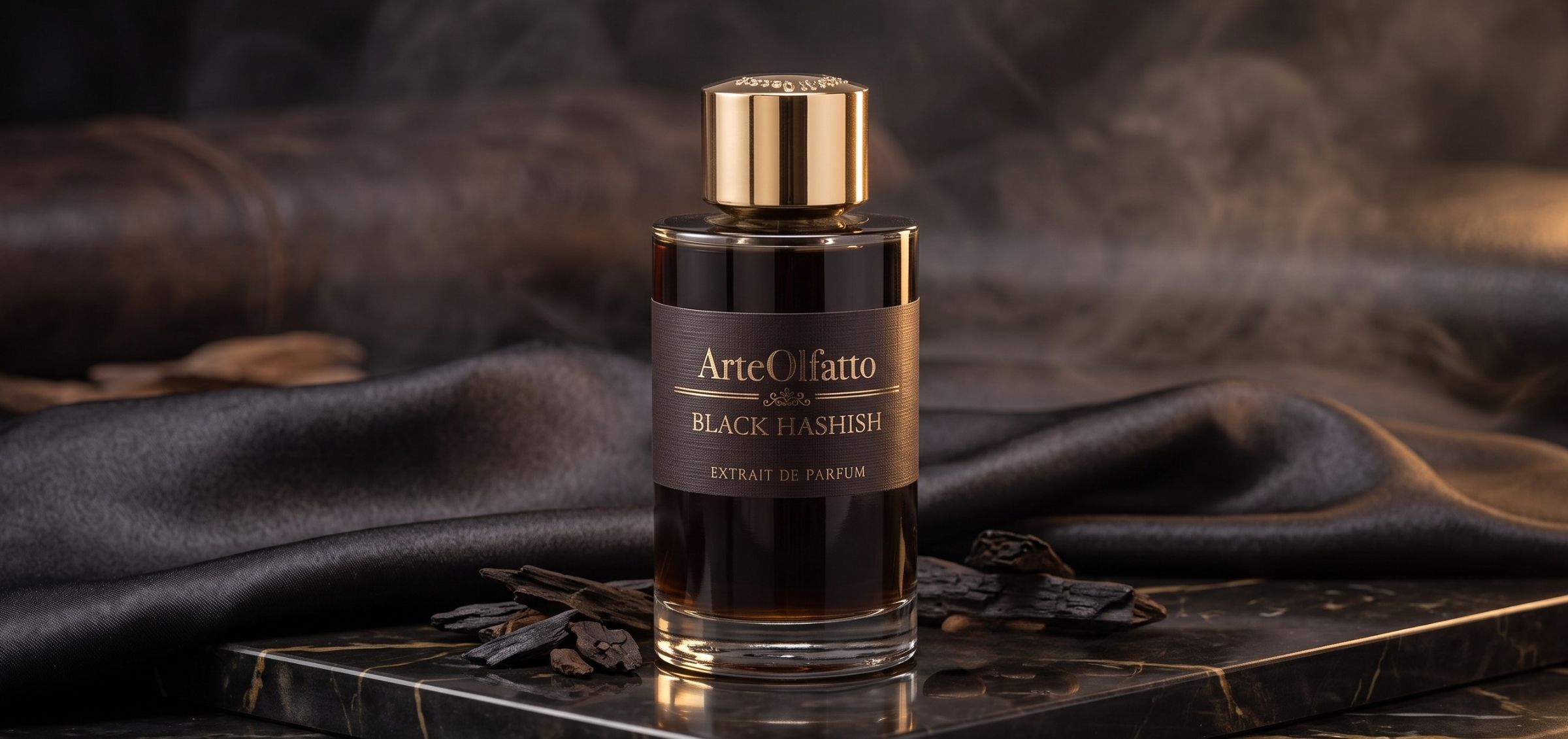Perfume bottle with gold cap and dark label reading 'ArteOlfatto Black Hashish' on a black marble surface with smoky backdrop.