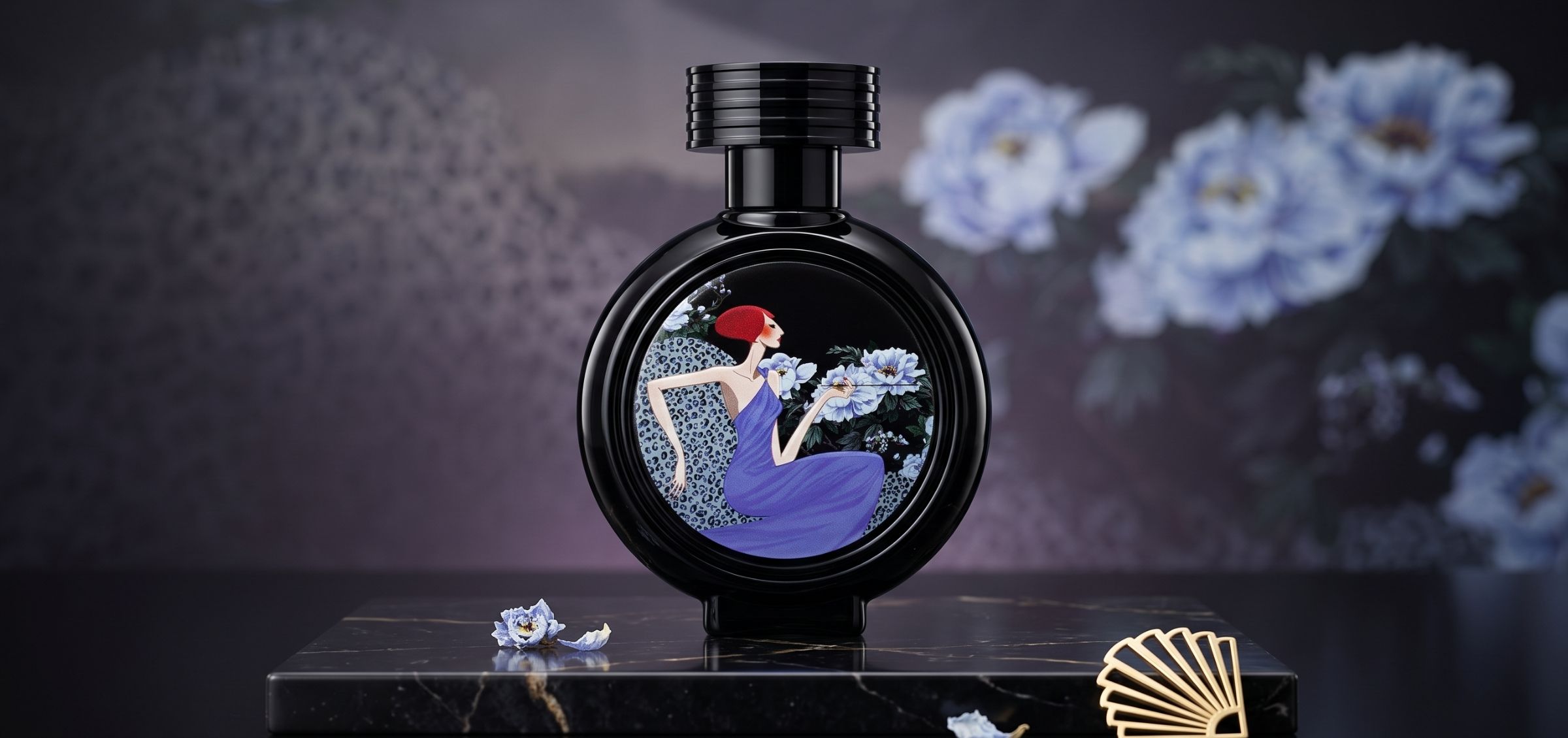 Black round perfume bottle with a decorative label showing a woman in a purple dress among blue flowers.