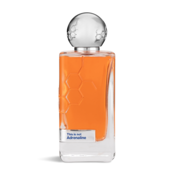 Perfume bottle with orange liquid and a round metallic cap, label reads 'This is not Adrenaline'.