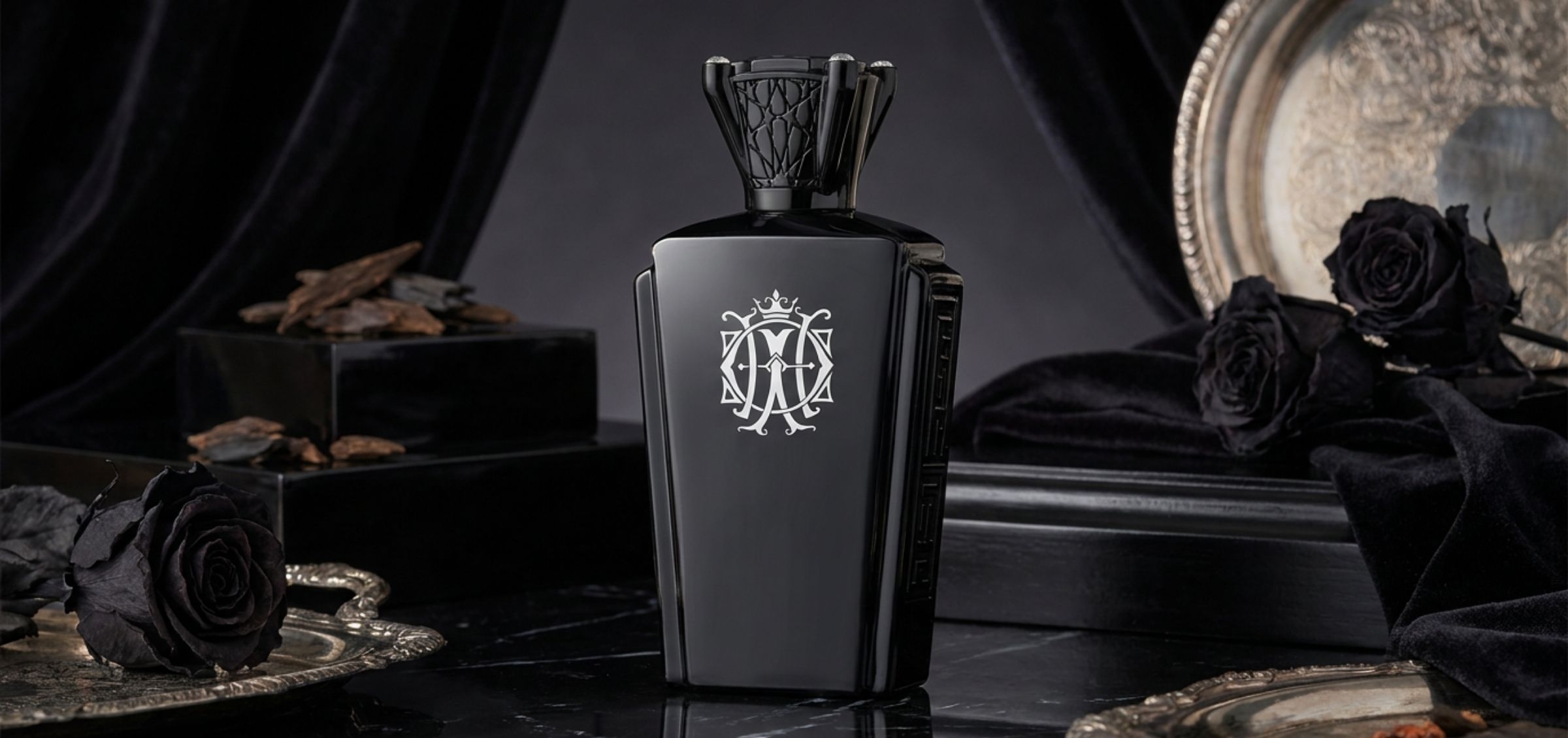 Luxurious black perfume bottle with a silver crown crest, set against a dark velvet backdrop.